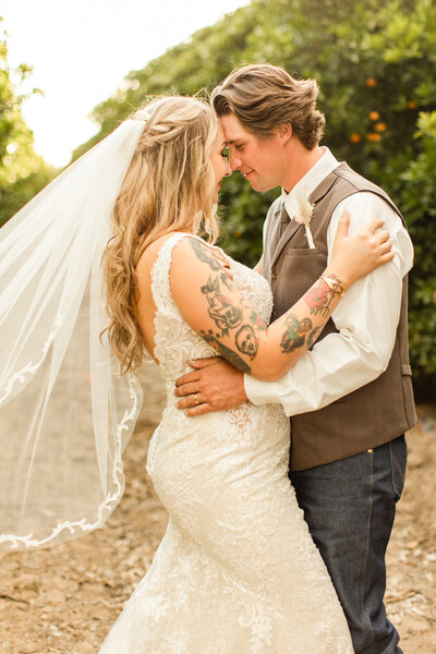 couple embracing with wedding veil