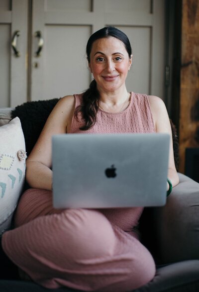 mariella smiling behind a  laptop