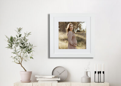 Pregnant mother watching her little girl touch her pregnant belly for their maternity photography session