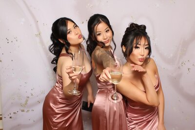 Friends posing with photo booth at event in Vancouver