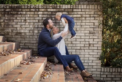 New dad holding newborn in lifestyle shoot in baby's nursery in Grayson, GA
