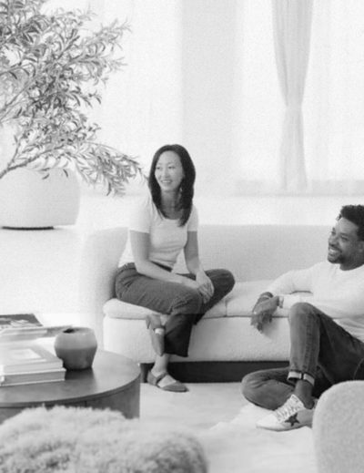 A man and woman hanging out on a couch in a sun-filled studio and event rental space in Chicago.