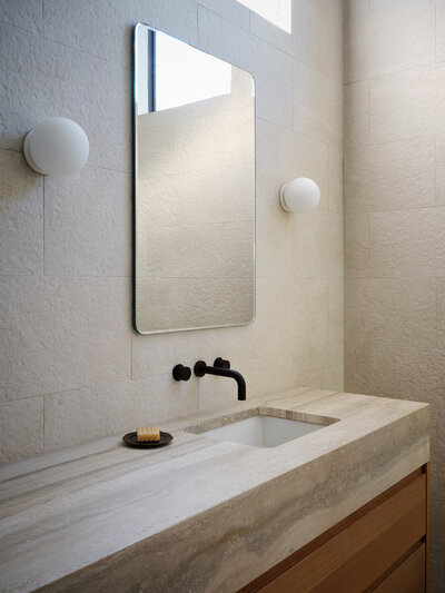 travertine-countertop-minimal-bathroom-oak-vanity-textured-tile-wall-austin-home-house-franc