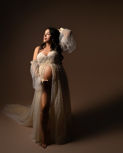 Off-shoulder tulle robe with dramatic volume, studio maternity photography styling