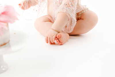 Chubby baby feet during first birthday cake smash at bay photographer One Good Shot Photography in Fresno, CA