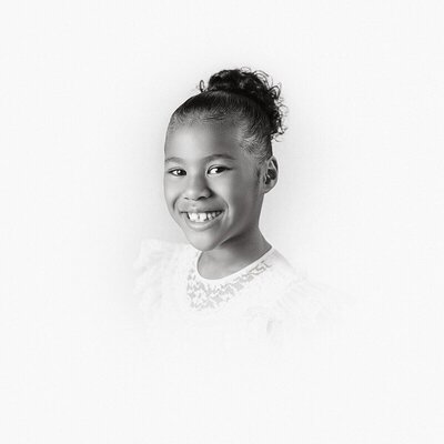 Authentic smiling portrait captured with children’s photography in Michigan

