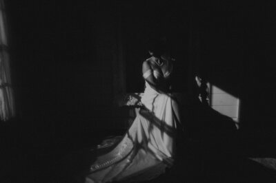 Bride twirling in gown at destination wedding ceremony, cinematic moody film style