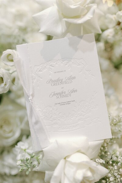 a custom wedding signage design  seating chart with white flowers and babys breath at a luxury alyssa amez design wedding