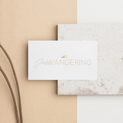 Jess Wandering logo on a business card