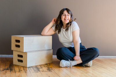 Smiling Photo of Eliana Melmed in a photography Studio for Headshots and small business branding