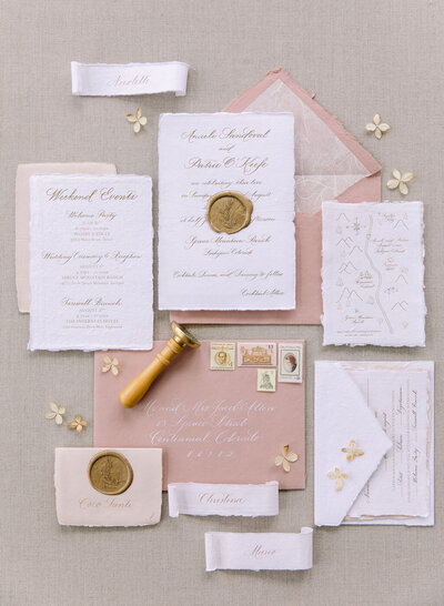 Pink and white wedding invitation suite with gold foil letterpress print on handmade paper with wax seal, custom map and weekend events card