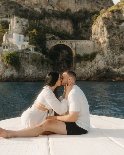 bride and groom kissing on boat