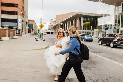 Helping bride bustle dress