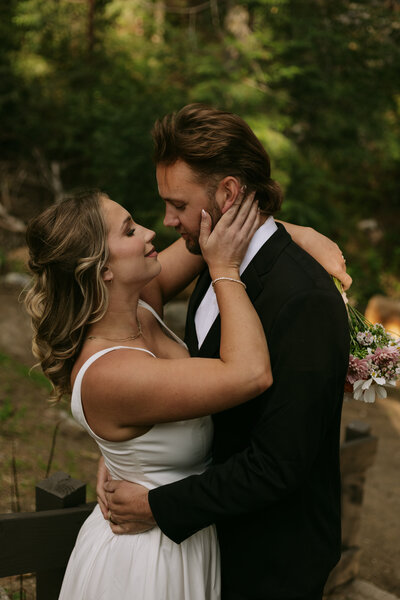 Ally caressing Josh's cheek during their bride and groom portraits for the Idyllwild elopement