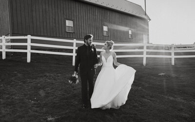 Bride and groom walking together looking at each other barn wedding