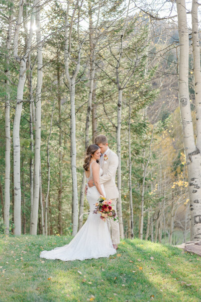 A bride walks down the floral-filled aisle for her Colorado wedding.
