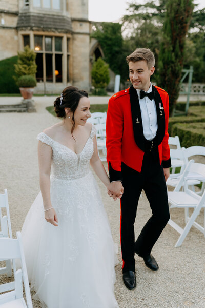 Bride and groom posing for portrait with white walls