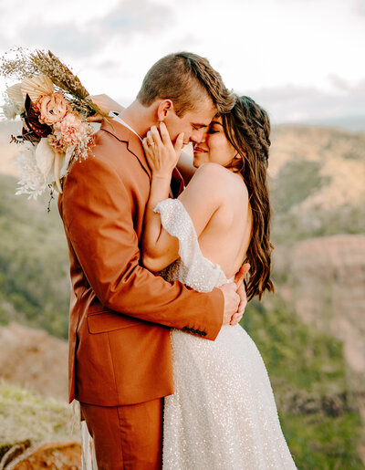 bride and groom in front of mountain
