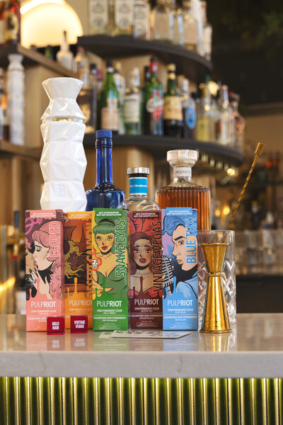 Pulp Riot hair color at a bar with drinks and dice for a creative brand campaign photoshoot