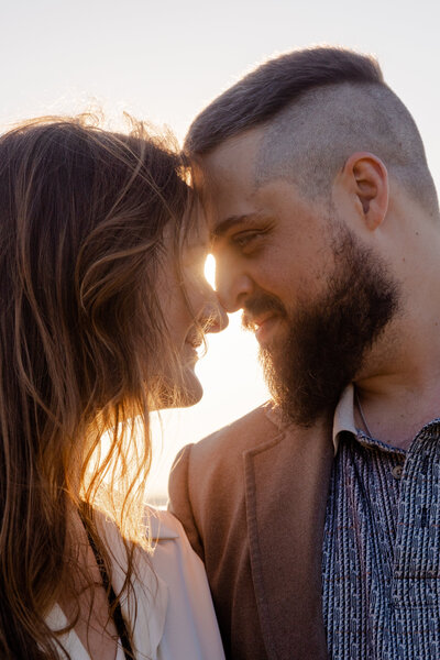 A photograph of a couple during a sunset.