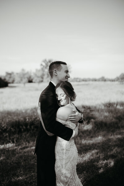 A couples embraces as they have their first look at Great Plains Nature Center - Ashley Cole Photography