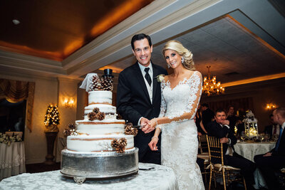 The English Manor | Bride and groom cutting cake during winter wedding | Ocean Township, New Jersey