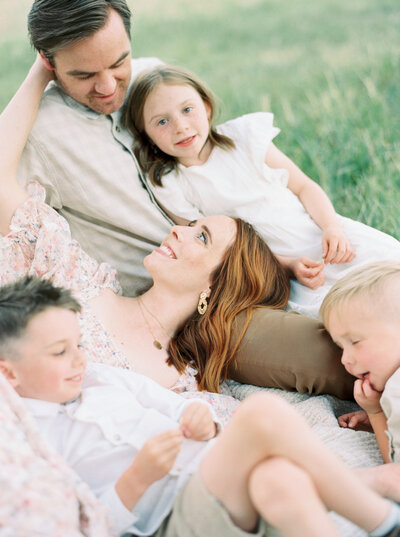 Family sitting together in a grassy field