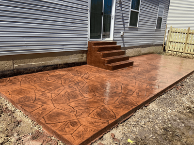 Stamped concrete patio installation by Black Bear Roofing & Exteriors.