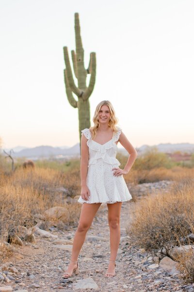 senior girl smiling at the camera in the arizona desert
