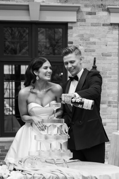 Mid Michigan wedding couple pouring champagne tower