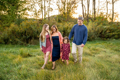 An Ohio family of four  takes Autumn family photos at Southside communiyt PArk located in New Philadelphia, Ohio.