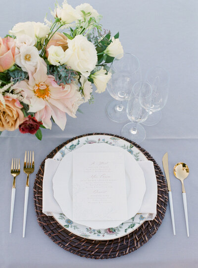 Gold flatware wedding reception dusty blue wicker organic floral design
