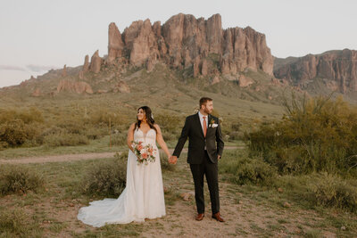 bride and groom sitting at a sweetheart table on their wedding day