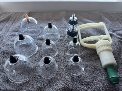 Devon Denys applying cupping therapy, an ancient technique for muscle relief and healing, offered in Colorado.