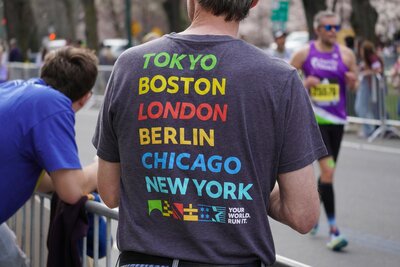 Man wearing a medium grey T-Shirt with Cities Listed