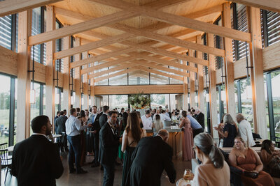 Crowd of wedding guests walking into a building