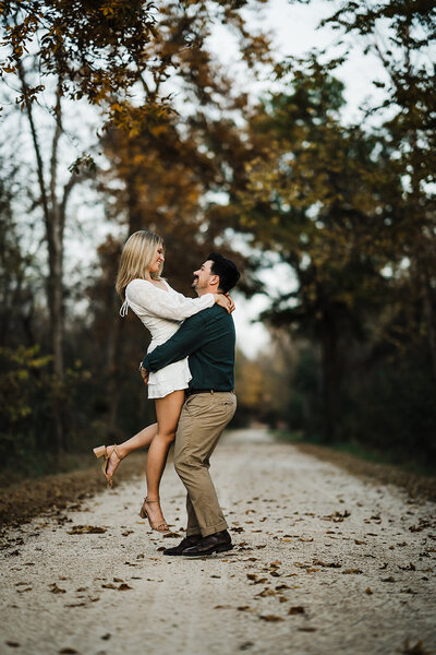 Engaged couple dancing in Wisconsin street at sunset.