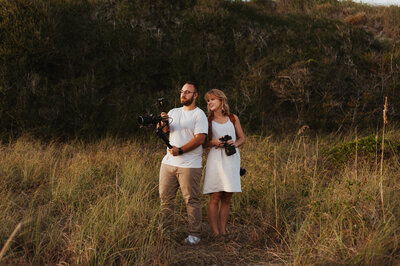 Alex and Anna Williams, creators of Williams Photo and Film holding cameras