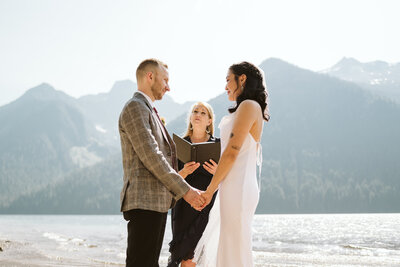 A photo of a couple saying their vows in front of the mountains surrounding Chilliwack Lake
