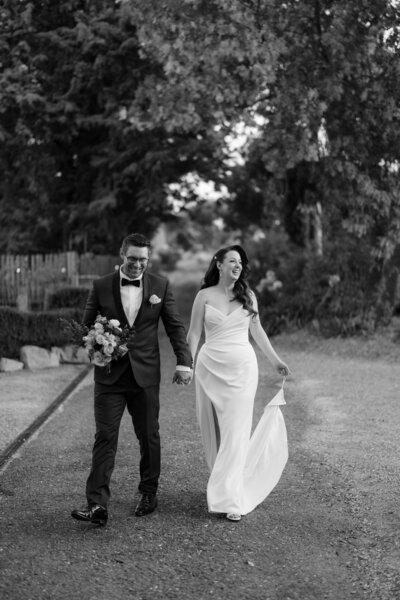 Documentary wedding photographer in Melbourne captures the happy couple walking towards their wedding reception.