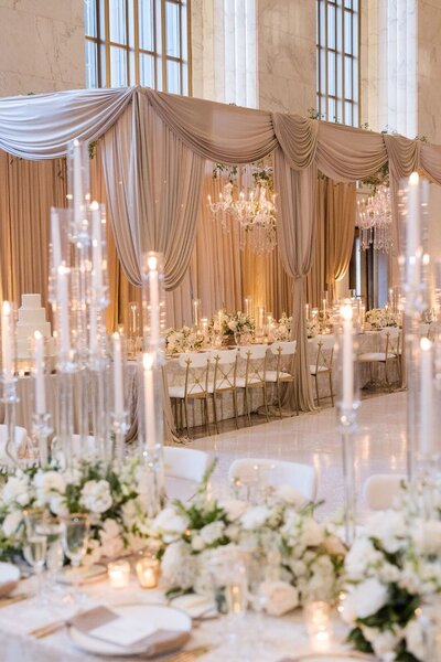 soft pink crystal glasses with floral pattern linens and plates, and yellow blue and pink florals arrangements designed by Sirpilla Soirees, Wedding Planners in Cleveland Ohio