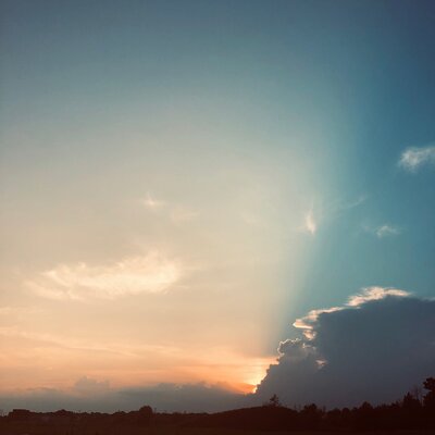 Sun setting behind a cloud