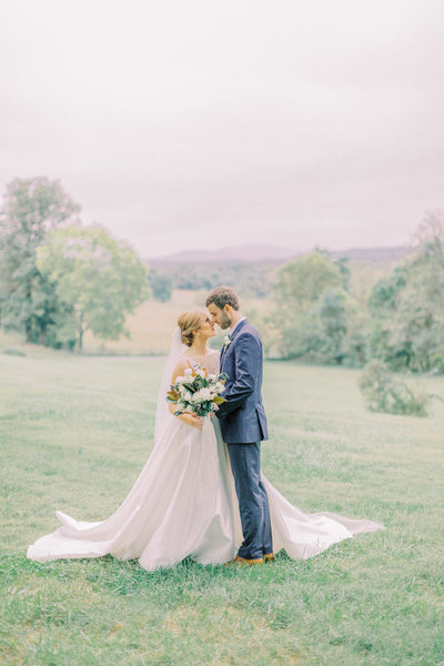 bride and groom share intimate moment in front of beautiful mountain backdrop at oatlands plantation