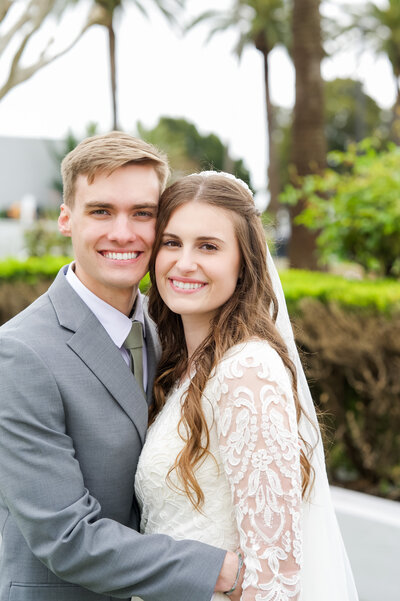 Smiling in the golden light of their wedding at the LDS Oakland Temple in Oakland, California