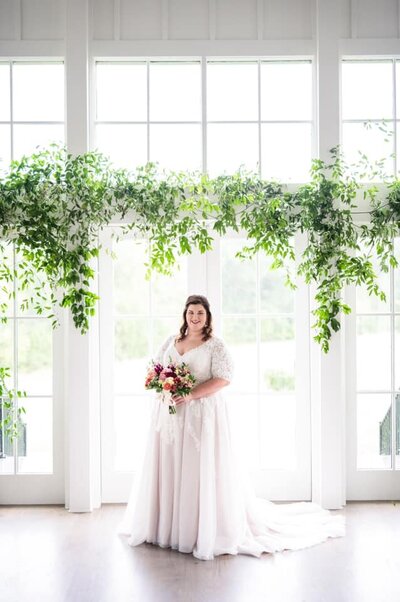 Bride at elegant venue with greenery