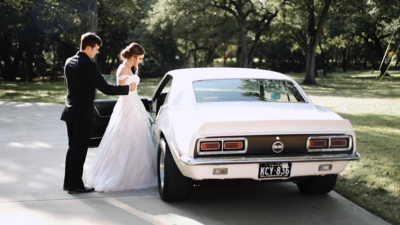 Luxury wedding film couple getting in getaway car