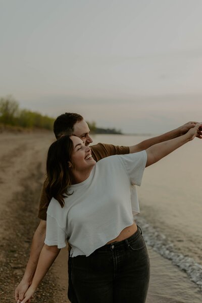 couple holding hands and walking through street