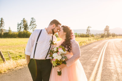 Bride and groom touch foreheads at golden hour