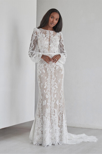 Our Spruce gown, constructed from our Anjo lace, features a high neck, puff sleeves and a dramatic open keyhole back. The scalloped lace cuffs add a unique yet romantic touch.