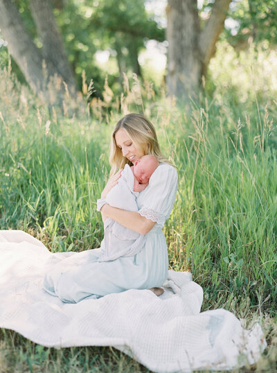 Newborn Photographer featuring mom holding newborn.